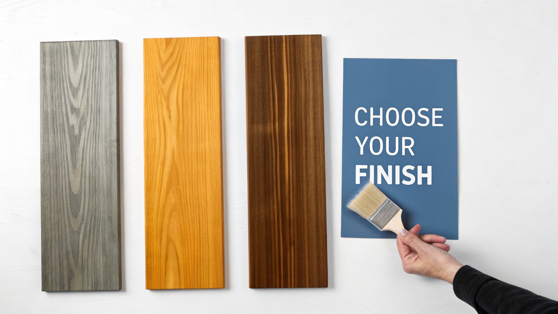Three wood planks with gray, natural, and dark finishes, with a 'Choose Your Finish' sign and paintbrush.