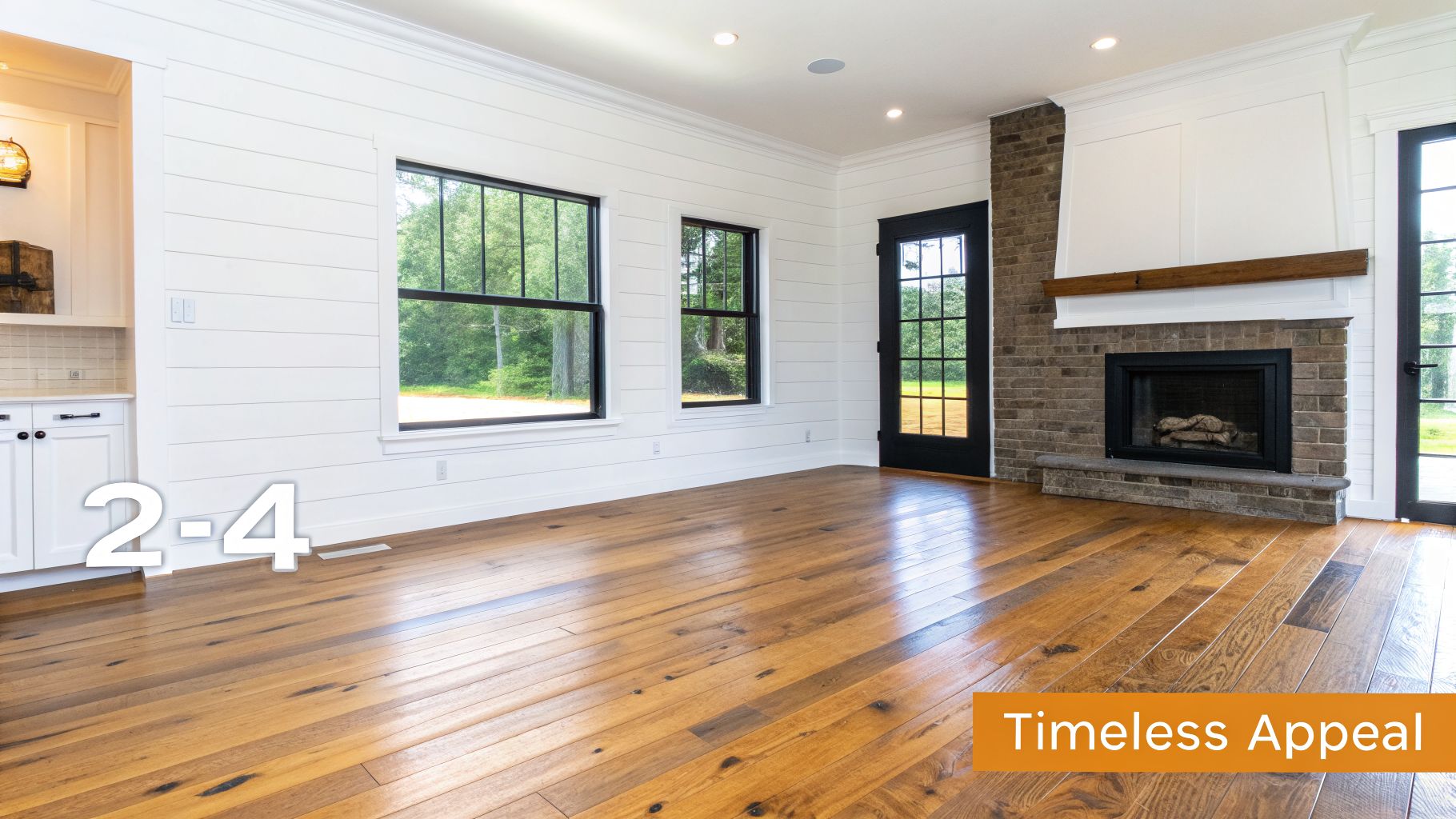A bright living room featuring white shiplap walls, warm hardwood floors, large windows, and a stone fireplace.
