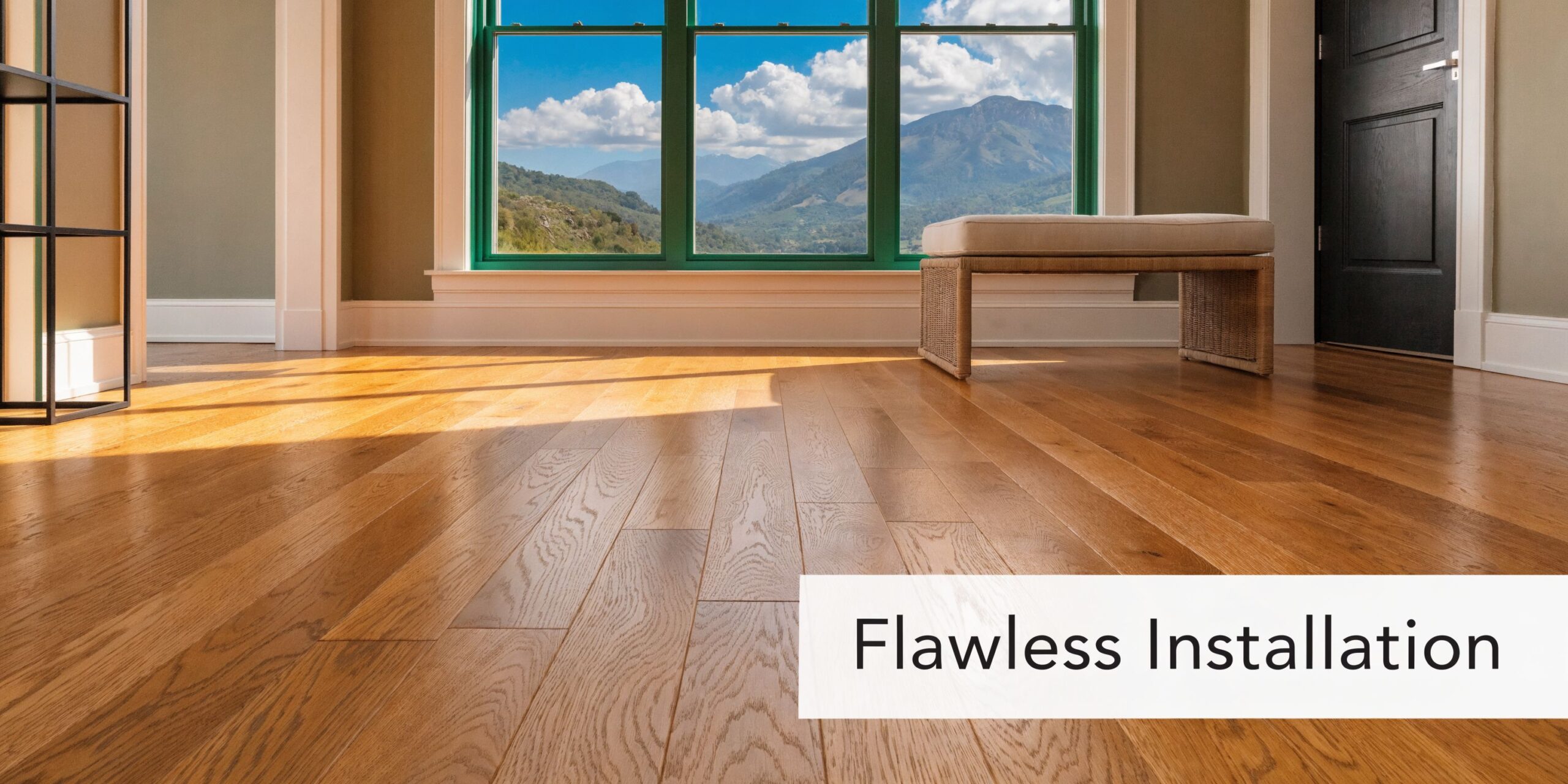 A sunlit room featuring beautiful hardwood floors with a view of mountains through the large windows.