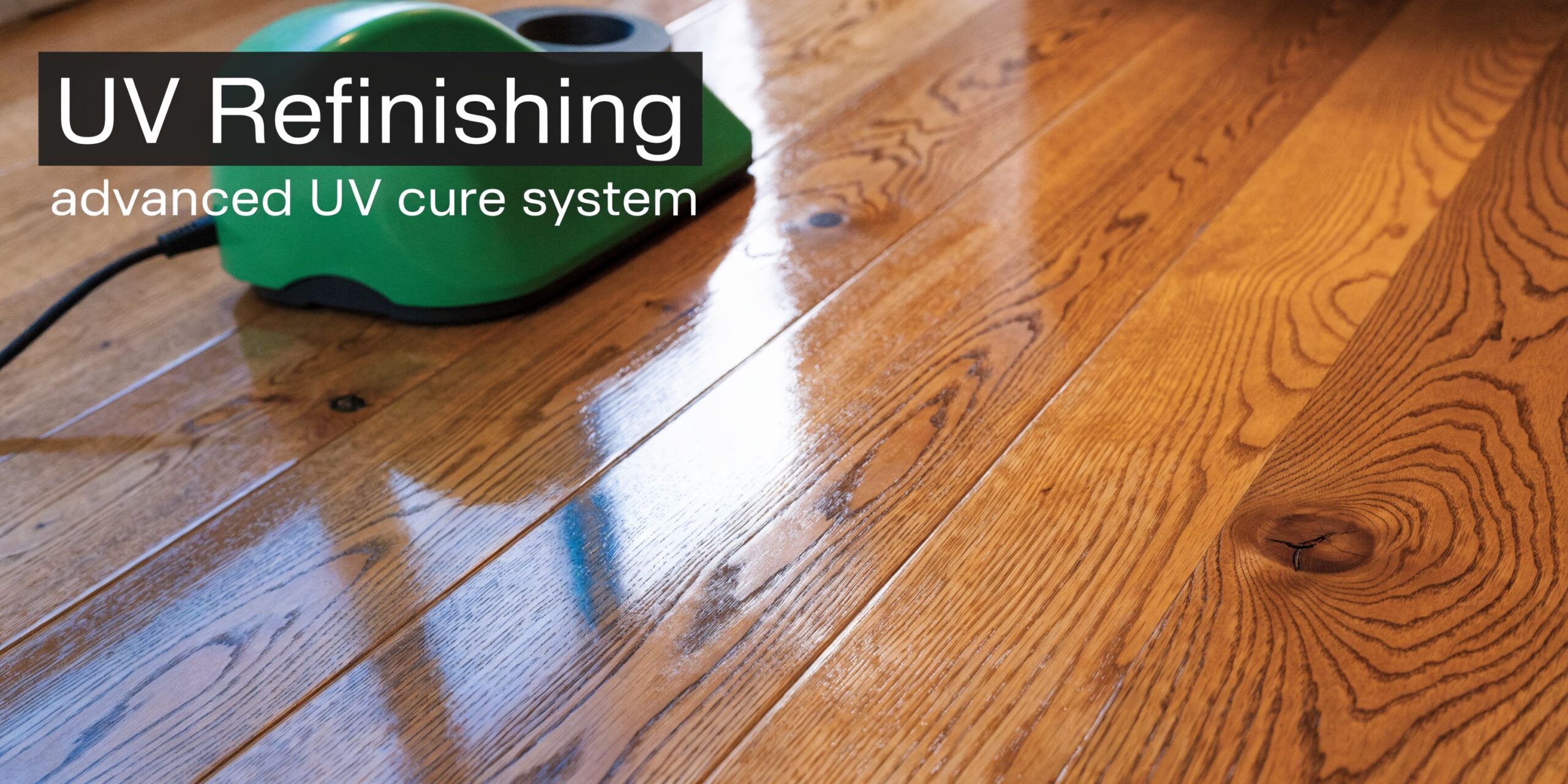 A UV light curing machine used for professional hardwood floor refinishing on a shiny wood surface.