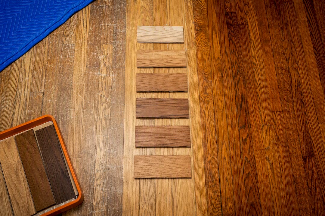 Hardwood stain samples beside floor sections