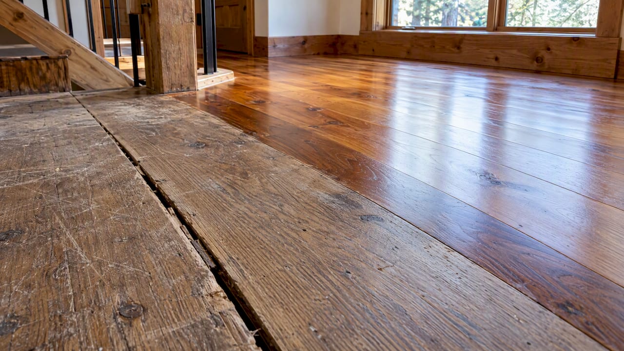 Seasonal gap between worn wide plank boards